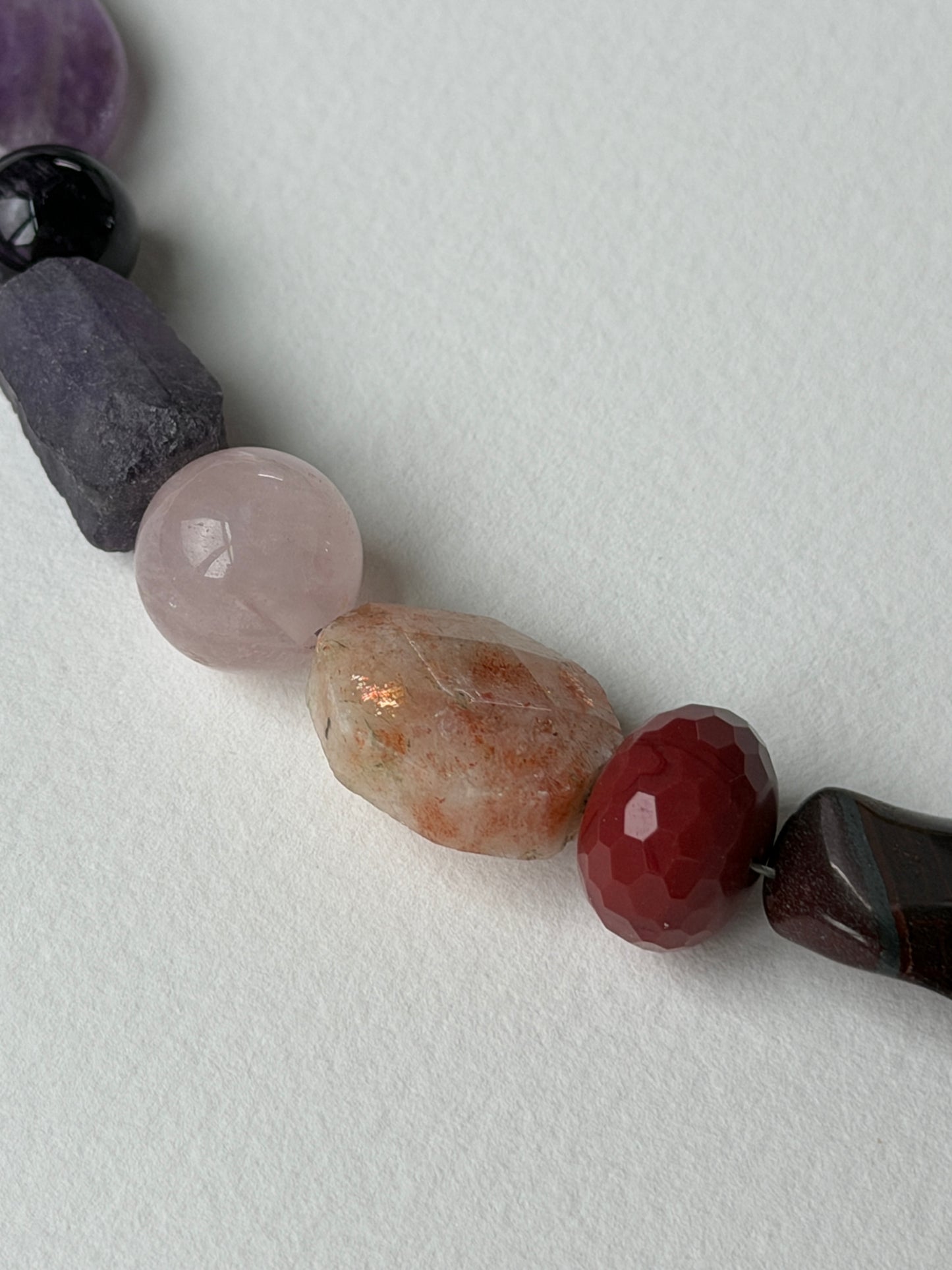 Meridian necklace close-up of red and orange stone beads